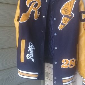 Runtz Letterman Jacket is fabricated from high-quality wool and genuine leather.